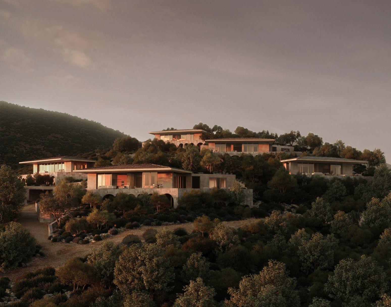 Elite villas on the hillside at dusk with lit windows