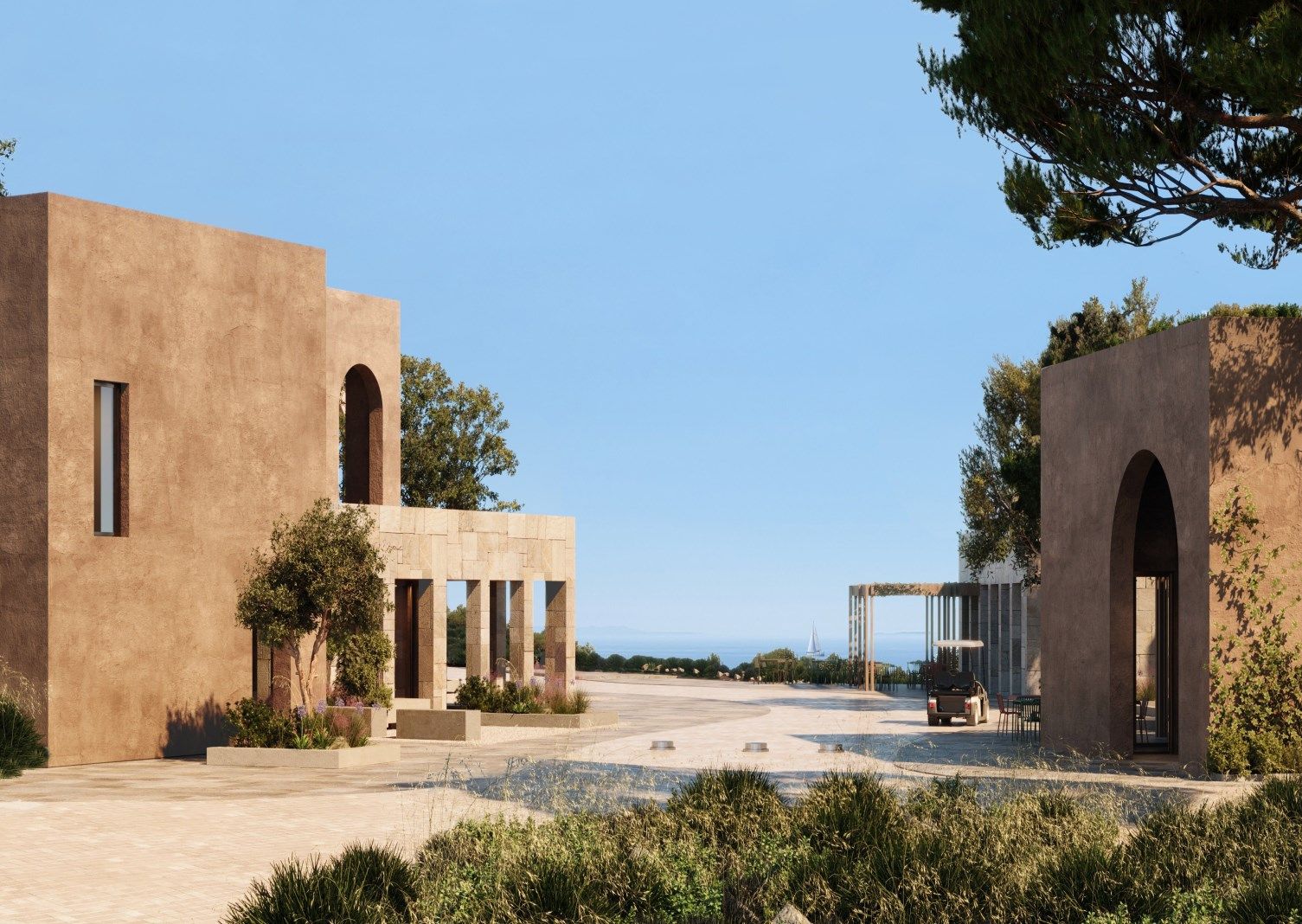Stone buildings of the welcome plaza with an arched gateway and pine trees