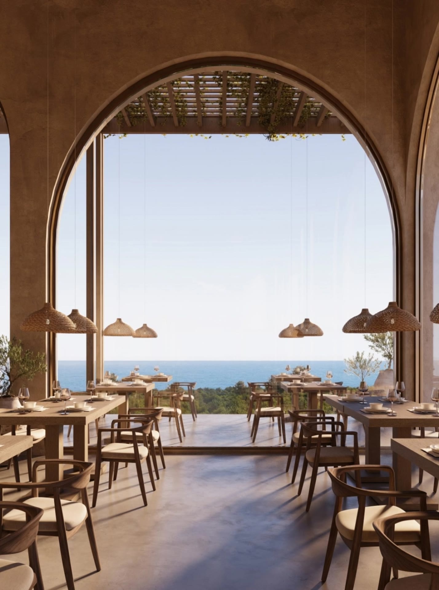 Dining hall seen through a tall stone arch, with woven lamps, timber chairs and the sea beyond