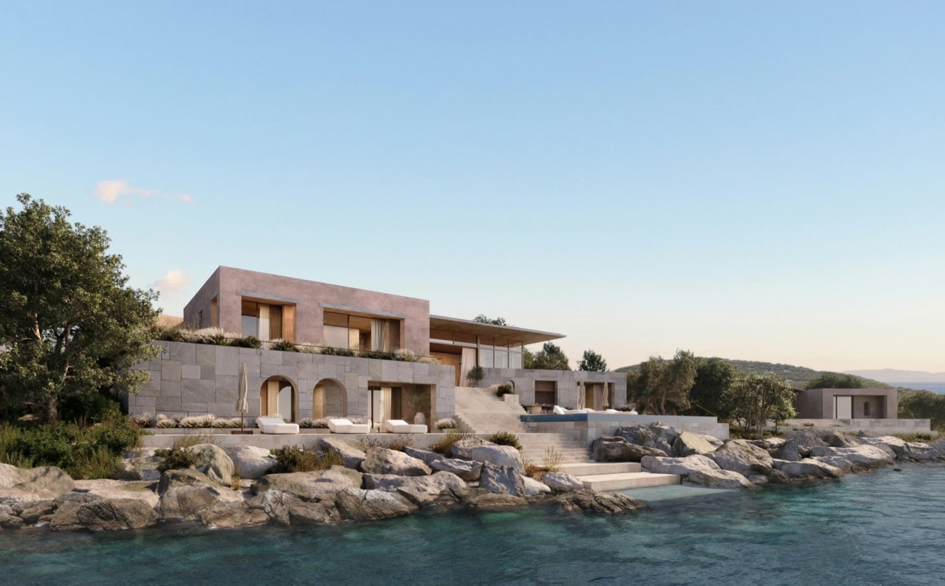 Elite villa of pale stone with arched openings, sitting on rocks at the water's edge
