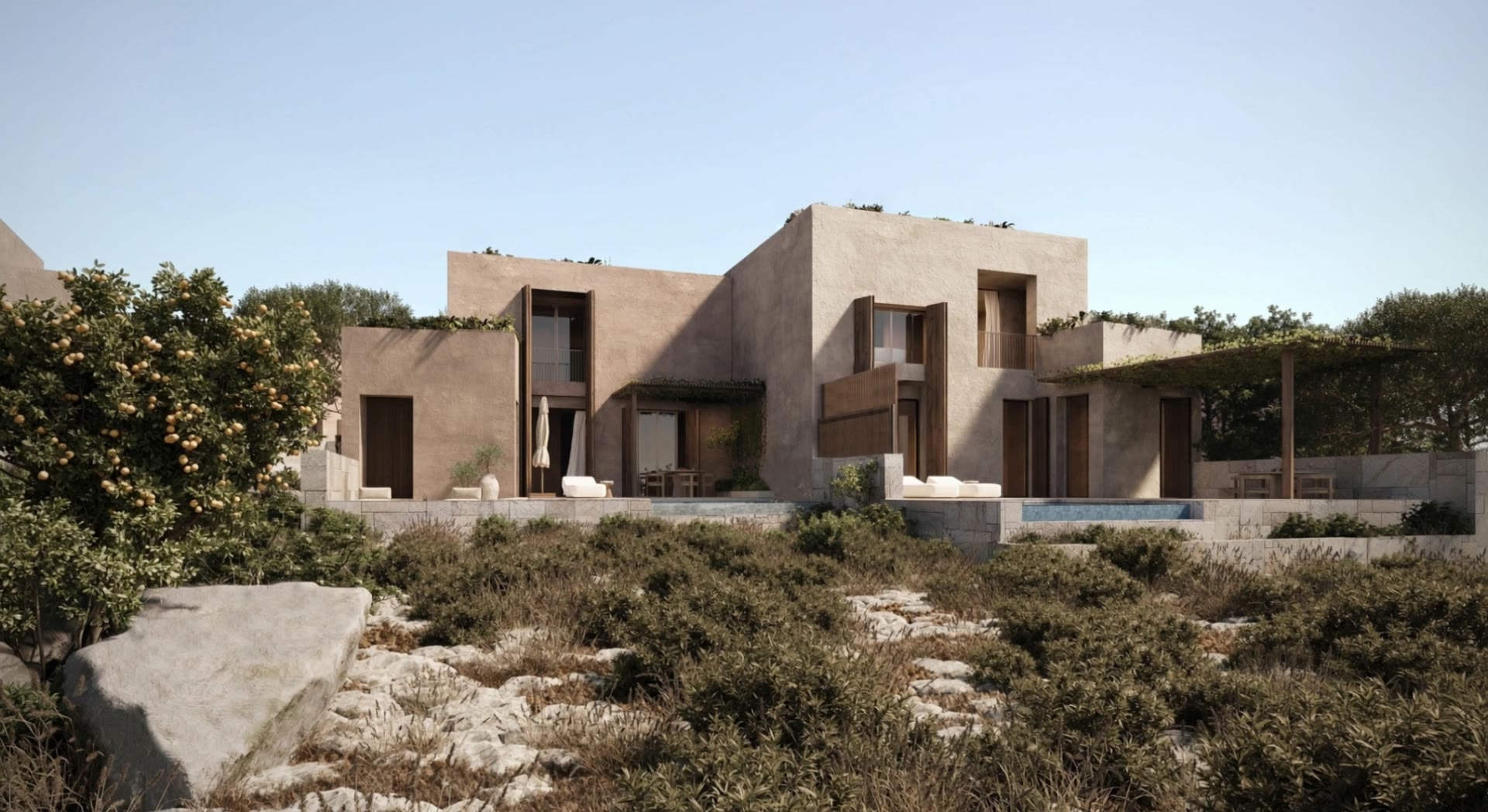 Boutique villa south from the garden: stepped stone volumes behind low scrub and rock